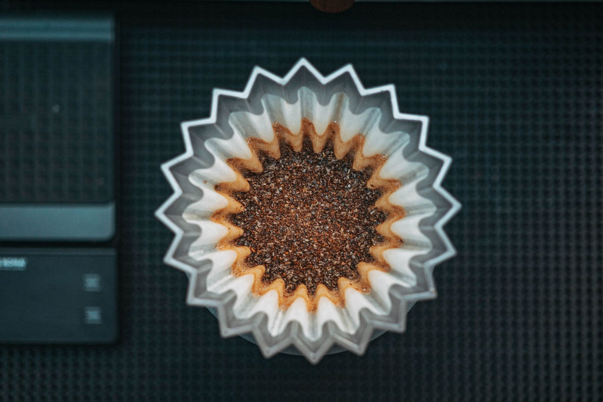 Stock lifestyle photo, not the actual product: coffee grounds in a paper filter, shown for Filtropa #4 Bleached Filter Papers (100 pack)
