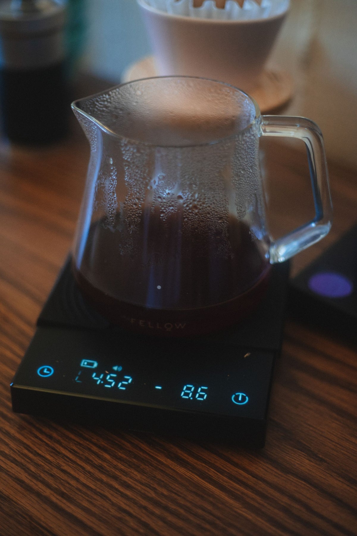 Stock lifestyle photo, not the actual product: glass pot of brewed coffee on a digital scale, shown for Brewista Smart Coffee Scale II