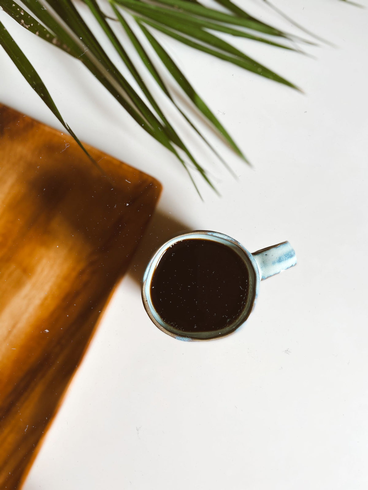 Stock lifestyle photo, not the actual product: black coffee in a ceramic mug, shown for Fellow Big Jo' Mug – Matte Black/Copper, 12oz